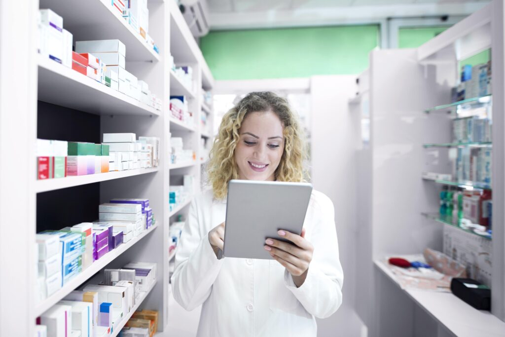 female pharmacist working in drug store min