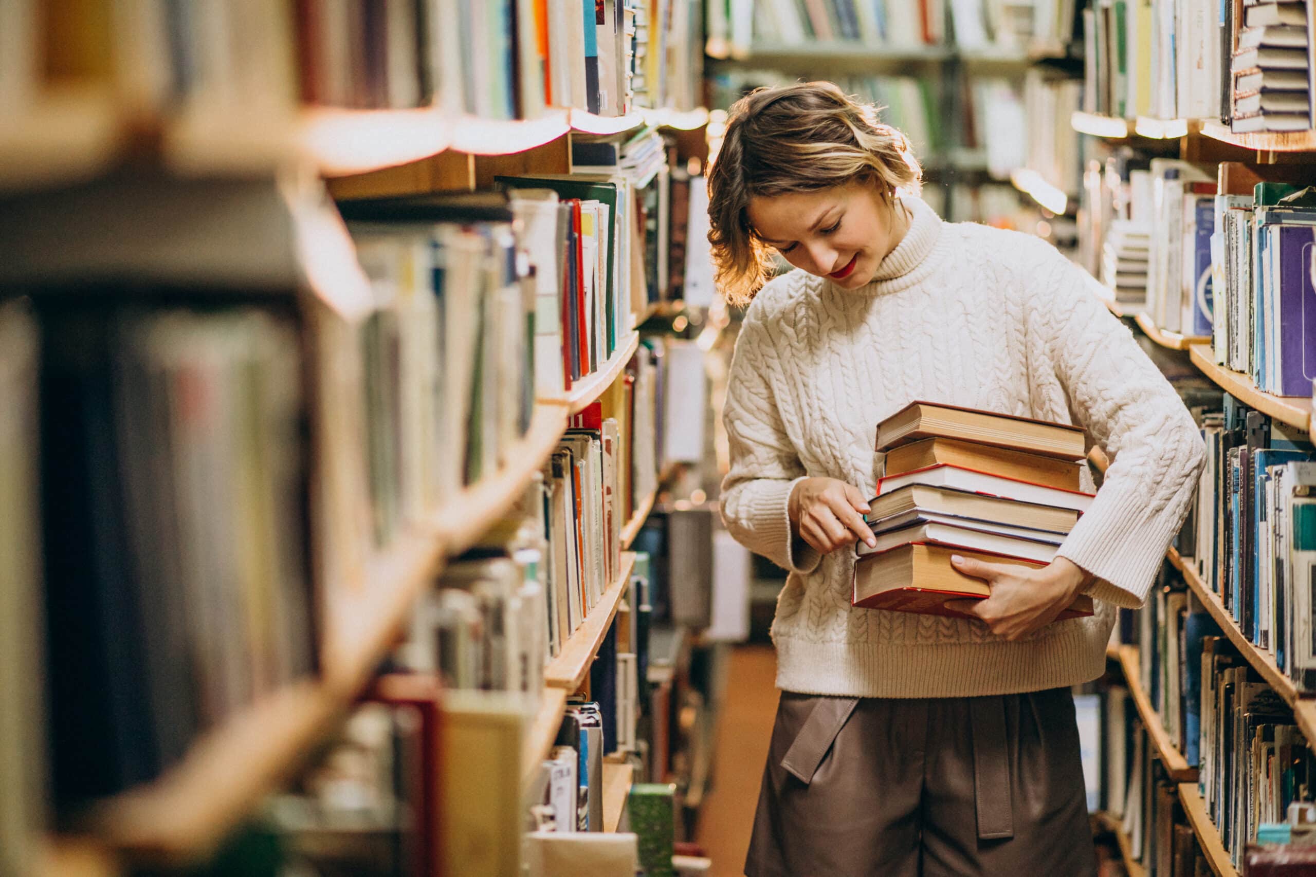 young woman studying at the library scaled