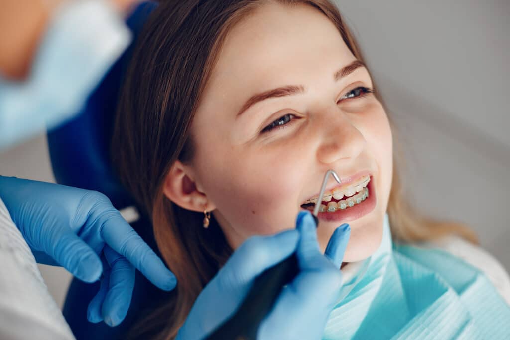 beautiful girl sitting in the dentist s office